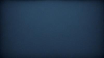 The primary subject of the image is a large, dark blue sky. The setting is a vast, open space with no visible landmarks or objects. The visual style is a natural, untouched landscape. The colors and mood are predominantly dark and moody, with the blue sky serving as the main focal point.