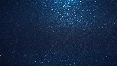 The primary subject of the image is a blue background with a pattern of glittering, shiny, and sparkling blue dots. The setting appears to be a dark, starry night, with the blue dots creating a mesmerizing and captivating visual effect. The visual style of the image is a combination of a photo and digital art, as the blue dots are arranged in a way that resembles a painting or a digital design. The colors and mood of the image are predominantly blue, creating a