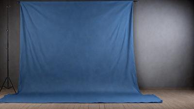 The primary subject of the image is a large blue sheet or curtain hanging on a wall. The setting is a room with a wooden floor, and the visual style appears to be a photo. The dominant colors in the image are blue and white, creating a calm and serene atmosphere.