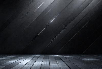 The primary subject of the image is a wooden floor with a black background. The setting is a dark room, and the visual style is a black and white photo. The colors and mood of the image are predominantly dark and moody, with the wooden floor and black background creating a sense of depth and contrast.