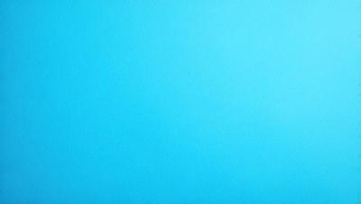 The primary subject of the image is a large, empty blue sky. The setting is a vast, open space with no visible landmarks or objects. The visual style is a natural, untouched landscape. The colors and mood are predominantly blue, creating a calm and serene atmosphere.