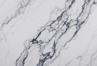 The primary subject of the image is a marble countertop with a white marble pattern. The setting is a kitchen or bathroom, as the countertop is a part of the counter. The visual style is a close-up of the marble countertop, showcasing its texture and pattern. The colors and mood of the image are predominantly white, giving it a clean and elegant appearance.