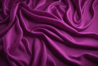 The primary subject of the image is a purple fabric, which is the main object, scene, or focus of the image. The setting or background is a purple sheet, and the visual style is a close-up of the purple fabric. The colors and mood of the image are predominantly purple, creating a calm and soothing atmosphere.