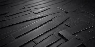 The primary subject of the image is a wooden floor with a black and white pattern. The setting is a room with a black and white checkered floor. The visual style is a close-up of the floor, showcasing the intricate pattern. The colors and mood of the image are predominantly black and white, giving it a classic and timeless appearance.