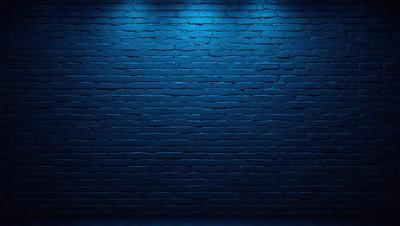 The primary subject of the image is a blue brick wall. The setting is a dark room with a blue brick wall as the background. The visual style is a photo, and the dominant colors are blue and black. The overall atmosphere is moody and dramatic.