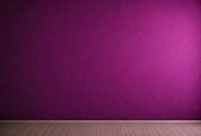 The primary subject of the image is a purple wall. The setting is a room with a wooden floor. The visual style is a photo, and the dominant colors are purple and pink. The overall atmosphere is calm and serene.