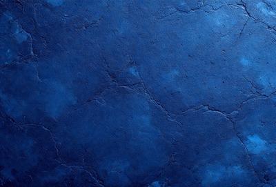 The primary subject of the image is a blue stone wall. The setting is a rocky surface, and the visual style is a close-up of the stone wall. The dominant colors are blue and grey, creating a calm and serene atmosphere.