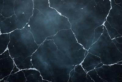 The primary subject of the image is a black and white photo of a marble wall with a blue tint. The setting is a dark room, and the visual style is a close-up of the wall. The colors and mood of the image are predominantly dark and moody, with the blue tint adding a touch of coolness to the overall atmosphere.