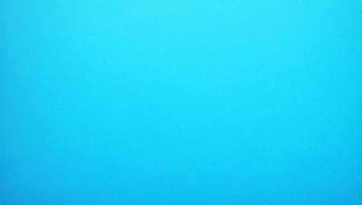 The primary subject of the image is a large, open, and empty blue sky. The setting is a vast, cloudless expanse, with no visible landmarks or objects. The visual style is a natural, untouched landscape, with no indication of digital manipulation or artistic elements. The colors and mood are predominantly blue, conveying a sense of tranquility and vastness.