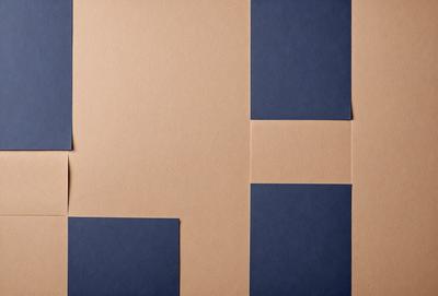 The primary subject of the image is a brown cardboard box. The setting is a table, and the visual style is a photo. The colors and mood of the image are predominantly brown and blue, giving it a warm and cozy atmosphere.