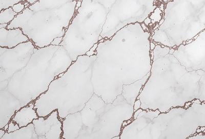 The image features a white marble surface with a pattern of white and brown veins. The marble appears to be a natural stone, giving it a unique and elegant appearance. The surface is smooth and shiny, reflecting light and creating a visually appealing environment. The overall atmosphere of the image is clean, sophisticated, and timeless.
