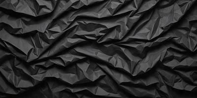 The primary subject of the image is a black fabric with a pattern of folded edges. The setting is a black background, and the visual style appears to be a patterned fabric or a textured surface. The colors and mood of the image are predominantly black, giving it a bold and striking appearance.
