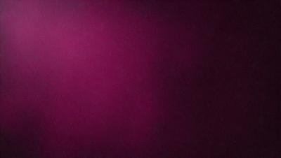 The primary subject of the image is a wall painted in a deep shade of pink. The setting is a room with a purple wall, and the visual style appears to be a photo. The dominant colors and overall atmosphere of the image are a mix of purple and pink, creating a warm and inviting ambiance.