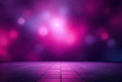 The primary subject of the image is a purple background with a pink glow. The setting is a dark room, and the visual style is a digital art or illustration. The dominant colors are purple and pink, creating a warm and inviting atmosphere.