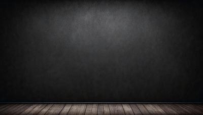 The primary subject of the image is a large, empty room with a black wall. The setting is a dark room, and the visual style is a photo. The colors and mood of the image are dark and moody, with the black wall and the lack of any other objects or decorations contributing to the overall atmosphere.