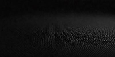 The primary subject of the image is a black background with a pattern of small white dots. The setting is a dark room, and the visual style appears to be a digital art or illustration. The dominant colors are black and white, creating a mood of simplicity and contrast.
