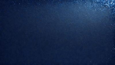 The primary subject of the image is a dark blue background with a few stars visible. The setting is a night sky, and the visual style is a photo. The colors and mood of the image are predominantly dark and moody, with the blue background and the stars adding a touch of brightness to the scene.