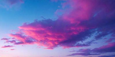 The primary subject of the image is a beautiful pink cloud in the sky. The setting is a cloudy sky, and the visual style is a photo. The dominant colors in the image are pink and purple, creating a serene and peaceful atmosphere.