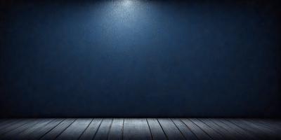 The primary subject of the image is a blue wall with a light shining on it. The setting is a dark room, and the visual style is a black and white photo. The dominant colors are blue and black, creating a moody atmosphere.