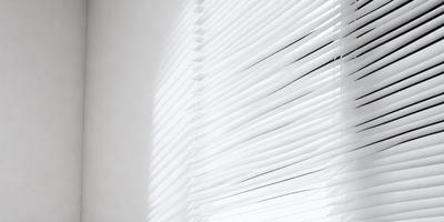 The primary subject of the image is a white shade or blind on a window. The setting is a room with a window, and the visual style appears to be a photo. The colors and mood of the image are predominantly white, giving it a clean and minimalist appearance.