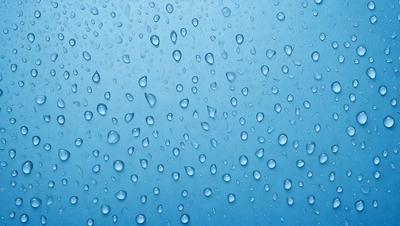 The primary subject of the image is a clear blue sky filled with water droplets. The setting is a cloudy day, and the visual style is a photo. The sky is the dominant color, and the overall atmosphere is serene and peaceful.