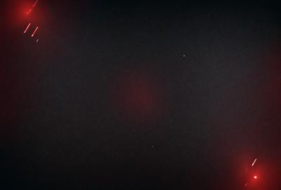 The primary subject of the image is a dark, star-filled sky. The setting is a black background, which contrasts with the bright stars. The visual style is a photo, capturing the beauty of the night sky. The colors and mood of the image are predominantly dark and moody, with the stars providing a touch of brightness.