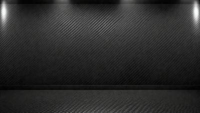 The primary subject of the image is a black wall with a patterned texture. The setting is a dark room, and the visual style appears to be a photo. The dominant colors are black and grey, creating a moody atmosphere.