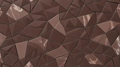 The primary subject of the image is a close-up of a brown tile with a geometric pattern. The setting is a wall, and the visual style appears to be a photo. The dominant colors are brown and beige, creating a warm and earthy atmosphere.