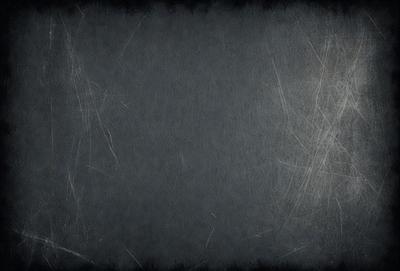 The primary subject of the image is a gray background with a few white streaks. The setting is a black and white photo, which gives it a classic and timeless appearance. The visual style is a black and white photograph, which adds a sense of nostalgia and simplicity to the image. The colors and mood are predominantly gray and black, creating a moody and dramatic atmosphere.
