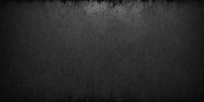 The primary subject of the image is a black and white photo of a wall. The setting is a room with a black and white background. The visual style is a black and white photo, giving it a classic and timeless appearance. The colors and mood of the image are predominantly black and white, creating a sense of depth and contrast.