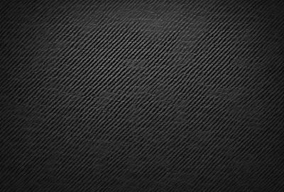 The primary subject of the image is a black and white patterned surface. The setting is a black background, and the visual style is a patterned texture. The dominant colors are black and white, creating a classic and timeless atmosphere.