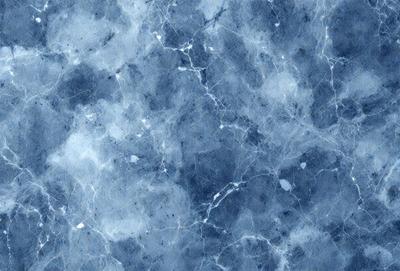 The primary subject of the image is a blue marble wall with a pattern of white dots. The setting is a room with a blue marble floor. The visual style is a close-up of the marble wall, showcasing its unique texture and pattern. The colors and mood of the image are predominantly blue, creating a calm and serene atmosphere.