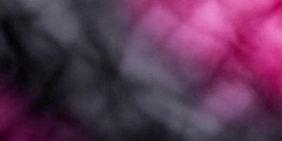 The primary subject of the image is a close-up of a purple and black checkered pattern. The setting is a dark room, and the visual style appears to be a photo. The dominant colors in the image are purple and black, creating a moody atmosphere.