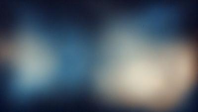 The primary subject of the image is a blue background with a white light source. The setting appears to be a dark room, and the visual style is a combination of a photo and digital art. The dominant colors are blue and white, creating a calm and serene atmosphere.
