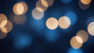 The primary subject of the image is a blue background with a pattern of bright lights, creating a visually appealing and artistic scene. The setting appears to be a dark room, with the lights creating a contrast against the darkness. The visual style of the image is a combination of photo and digital art, as it captures the essence of a photograph while also showcasing the artistic pattern created by the lights. The colors and mood of the image are predominantly blue, with the bright lights adding a sense of energy and