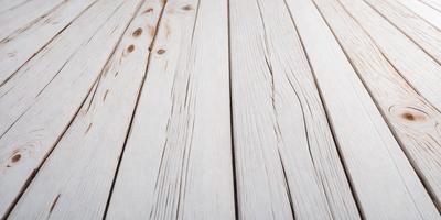 The primary subject of the image is a wooden floor with a white surface. The setting is indoors, possibly in a room or a house. The visual style is a close-up of the wooden floor, showcasing its texture and details. The colors and mood of the image are predominantly white, giving it a clean and minimalist appearance.
