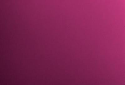 The primary subject of the image is a large, purple wall. The setting is a room with a pink background. The visual style is a close-up of the wall, showcasing its color and texture. The dominant colors are purple and pink, creating a warm and inviting atmosphere.