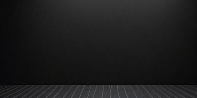 The primary subject of the image is a black wall with a leather texture. The setting is a room with a wooden floor. The visual style is a close-up of the wall, showcasing its texture and color. The dominant colors are black and brown, creating a moody atmosphere.