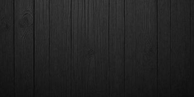 The primary subject of the image is a wooden floor. The setting is a dark room, and the visual style is a black and white photo. The colors and mood of the image are predominantly dark, creating a moody atmosphere.