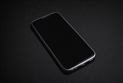 Primary subject: A black cell phone
Setting/background: A black background
Visual style: Photo
Colors and mood: Black and dark, with a sense of mystery
