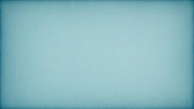 The primary subject of the image is a large, blue sheet of paper. The setting is a blank, blue background, which creates a clean and uncluttered visual style. The colors and mood of the image are predominantly blue, giving it a calm and serene atmosphere.