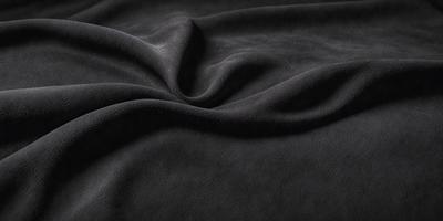 The primary subject of the image is a black fabric, which appears to be a piece of cloth or a blanket. The setting is a dark background, which contrasts with the black fabric. The visual style is a close-up of the fabric, showcasing its texture and details. The colors and mood of the image are predominantly dark, with the black fabric being the main focus.