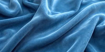 The primary subject of the image is a blue fabric, possibly a blanket or a piece of clothing. The setting is a room with a blue background, which creates a cohesive and visually appealing environment. The visual style is a close-up of the blue fabric, showcasing its texture and color. The dominant colors in the image are blue, creating a calm and soothing atmosphere.