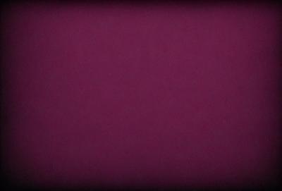 The primary subject of the image is a purple background. The setting is a dark room, and the visual style is a close-up of the purple wall. The colors and mood of the image are predominantly purple, creating a calm and serene atmosphere.