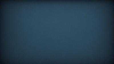 The primary subject of the image is a large, dark blue sky. The setting is a vast, open space with no visible landmarks or objects. The visual style is a natural, untouched environment. The colors and mood are predominantly dark and moody, with the blue sky serving as the main focal point.