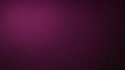 The primary subject of the image is a purple wall. The setting is a room with a purple wall, and the visual style is a close-up of the wall. The colors and mood of the image are predominantly purple, creating a calm and serene atmosphere.