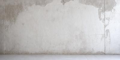 The primary subject of the image is a large, white, cement wall. The setting is a room with a bare, white wall, and the visual style is a photo. The colors and mood of the image are predominantly white, giving it a clean and minimalist appearance.
