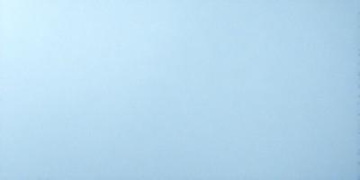 The primary subject of the image is a large, empty blue sky. The setting is a vast, open space with no visible landmarks or objects. The visual style is a natural, untouched landscape. The colors and mood are predominantly blue, creating a calm and serene atmosphere.