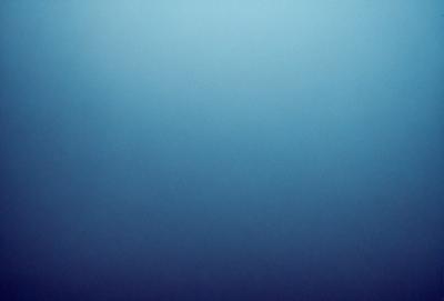 The primary subject of the image is a large, open, and dark blue sky. The setting is a vast, empty space with no visible landmarks or objects. The visual style is a natural, untouched, and unaltered representation of the sky. The colors and mood convey a sense of vastness, tranquility, and calmness.