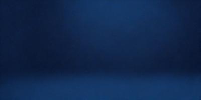 The primary subject of the image is a blue wall. The setting is a dark room, and the visual style is a photo. The dominant colors are blue and black, creating a calm and serene atmosphere.
